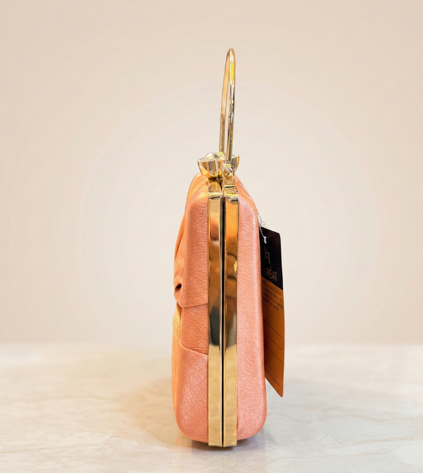 Rose gold clutch handbag with gold handle and crystal clasp top view