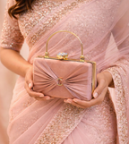 Rose gold wedding clutch bag styled with saree for festive look